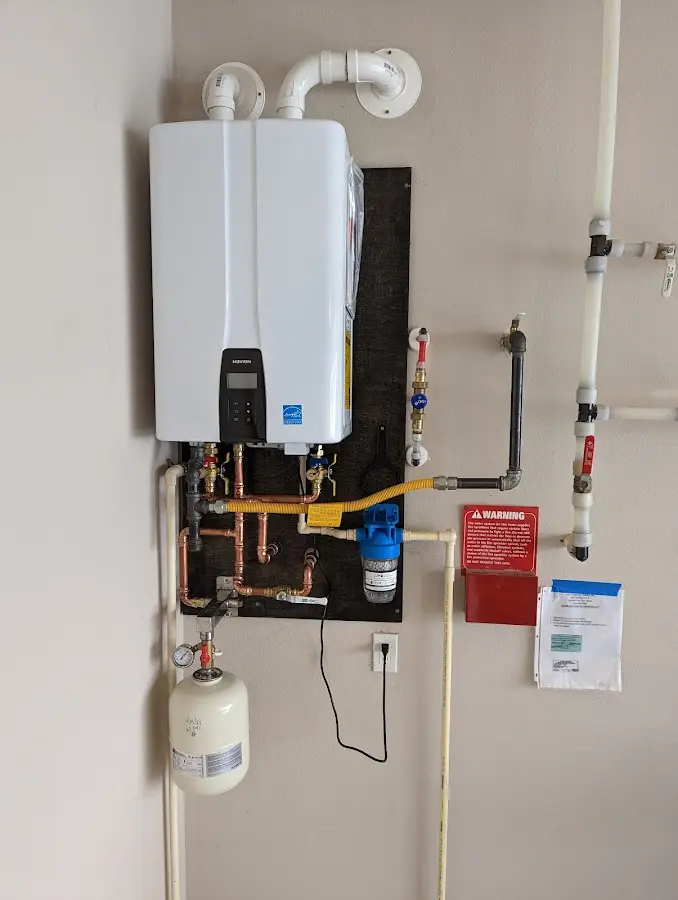 Professional plumber installing copper piping in a Greeneville home